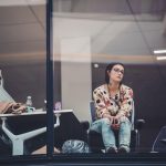 A dissatisfied employee looking through the office window