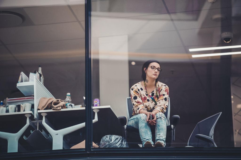 A dissatisfied employee looking through the office window