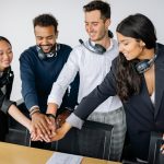 Employees posing happy together because of a good feedback culture