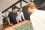 3 employees playing table football in a PayFit break room.