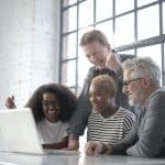 Employees from a hybrid company having an online meeting at the office