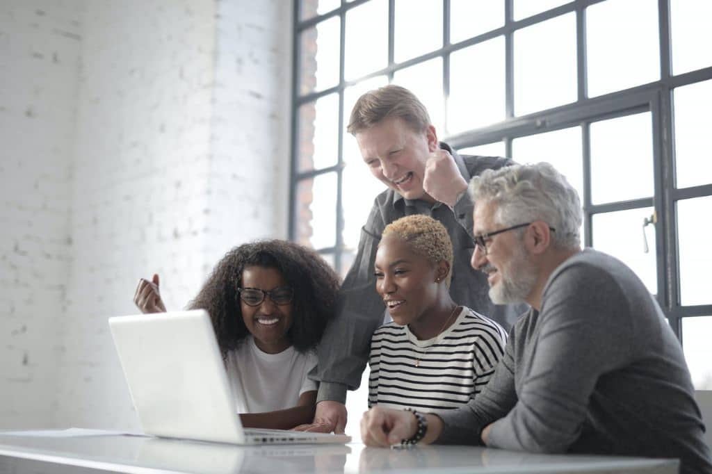 Employees from a hybrid company having an online meeting at the office