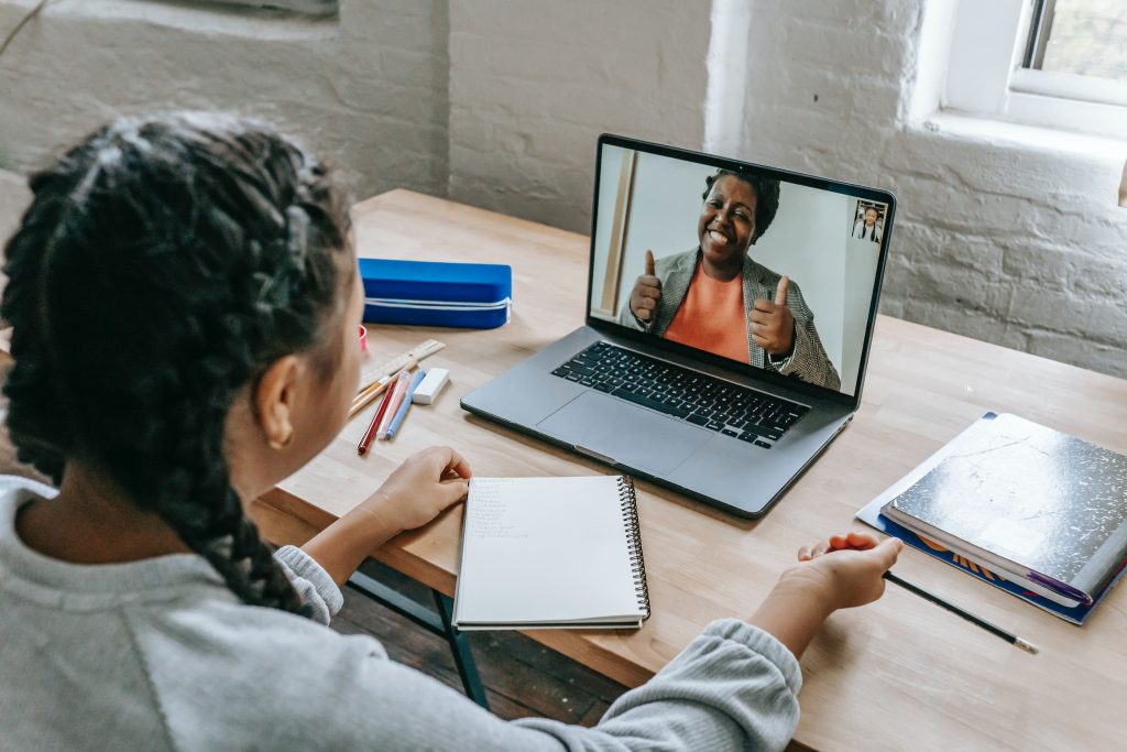 2 employees chatting on video call while working from home.