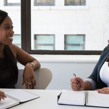 Two female employees giving positive feedback to each other