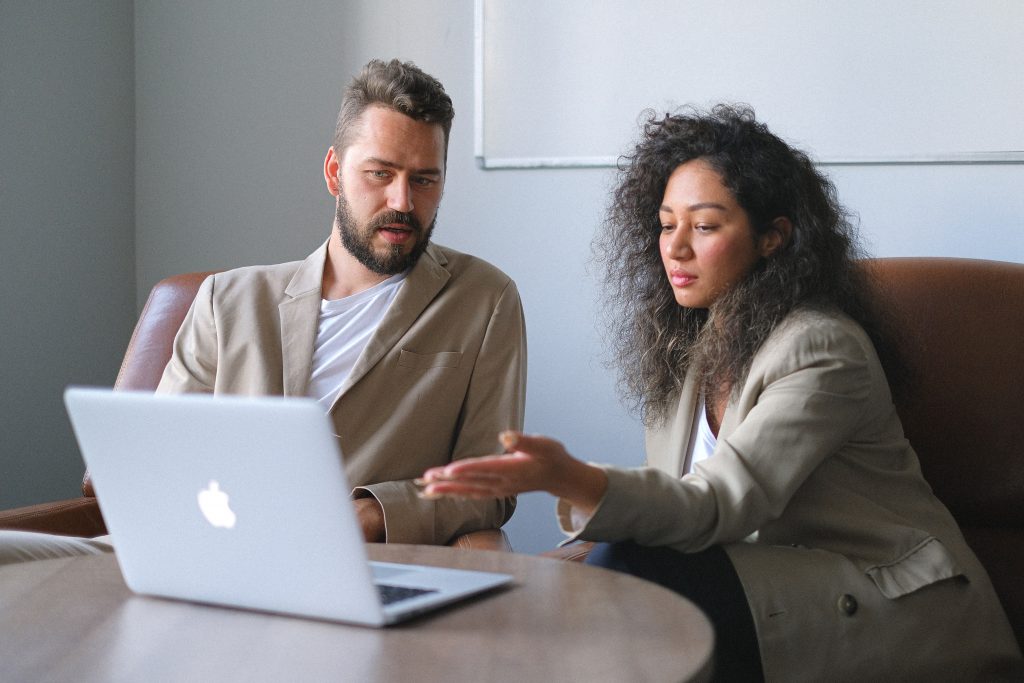 2 employees evaluate a performance review at the office.