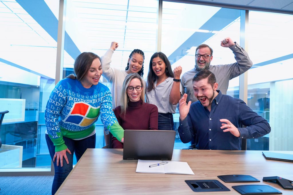 Microsoft employees cheering at the office