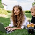 Remote worker works with their son in the garden.