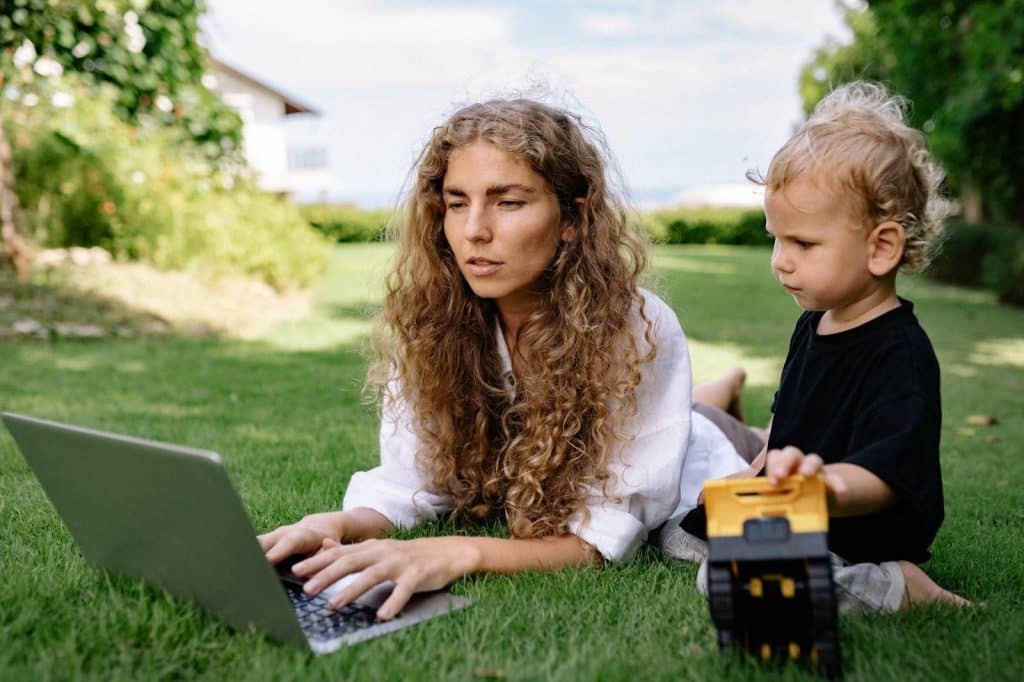 Remote worker works with their son in the garden.