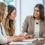 HR manager giving constructive feedback to two employees