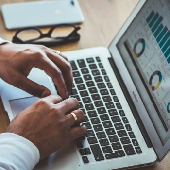An HR professional looking at employee engagement statistics on his laptop