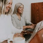 A couple of coworkers typing in their laptops